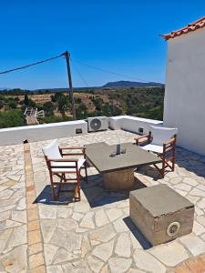 a patio with a table and chairs on a roof at Kastri in Kythira