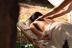 a woman laying on a bed getting a massage at Quinta da Luz - A Luxury Boutique B&B in Silves