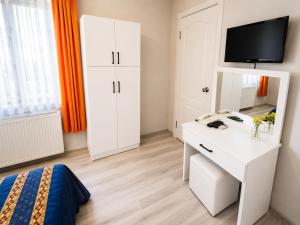 a bedroom with a white desk and a mirror at Anadolu Hotel in Istanbul