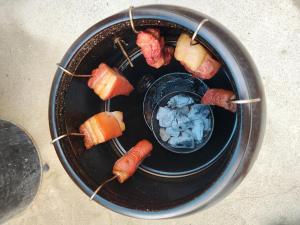 a plate of food with bacon and carrots on sticks at Donghae Mookhoae Pension in Donghae