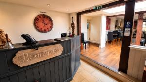 a restaurant with a sign that says be enchantment at The George and Dragon Inn in Long Melford