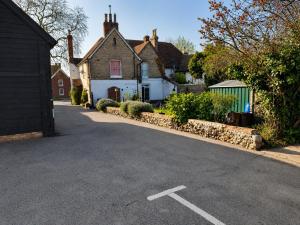 a street with a white house and a building at The George and Dragon Inn in Long Melford +7 photos