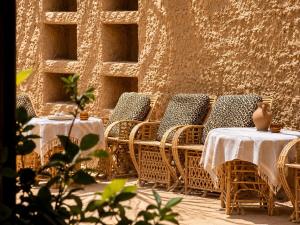 a group of tables and chairs with white table cloth at Soléi Old Town in Siwa