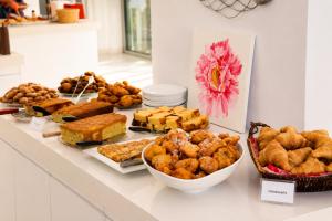a buffet with various types of food on a counter at Corfu Hotel in Ayia Napa