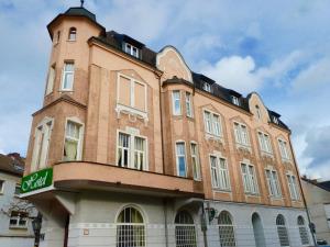 a large brick building with a clock tower on it at Hotel Zum Bügeleisen in Duisburg