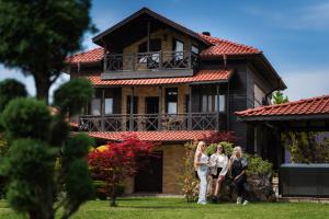 three women standing in front of a house at Villa Ploski in Ploski