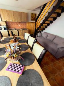 a conference room with a table and a couch at Cabana Geta&Mircea in Beclean