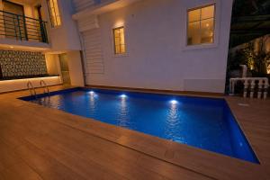 a swimming pool in the middle of a house at Hotel H F at Assagao North Goa in Assagao