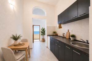 a kitchen with a table and a sink and a dining room at SunSeoce Apartments in Budva