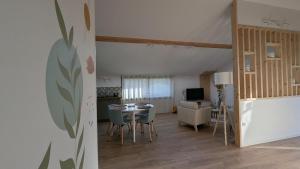 a kitchen and living room with a table and chairs at Appartement in Lorp Sentaraille