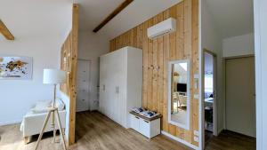 a bedroom with wood paneled walls and a mirror at Appartement in Lorp Sentaraille