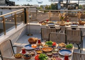 a table with plates of food on a balcony at elisa hotel in Istanbul