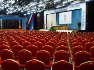 an empty auditorium with red chairs and a screen at RELAX-zepter in Vrnjačka Banja +32 photos