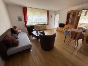 a living room with a couch and a table at Ferienpark Wehrda in Haunetal