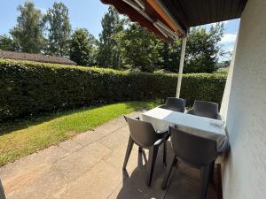 a table and chairs under an umbrella on a patio at Ferienpark Wehrda in Haunetal