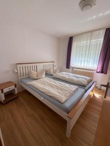 a bedroom with a large bed in a room at Ferienpark Wehrda in Haunetal