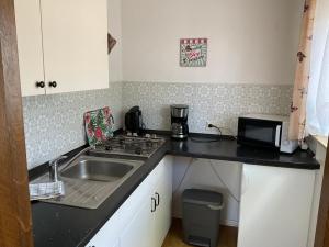 a small kitchen with a sink and a stove at Ferienpark Wehrda in Haunetal
