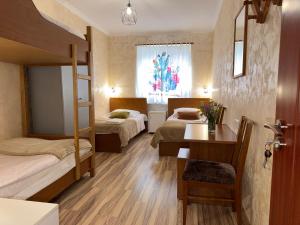 a bedroom with two bunk beds and a desk at Aregak B&B and Tours in Goris