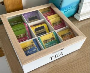 a box full of tea packets sitting on a table at Trethvor House FREE PARKING, Ensuite Double Quiet residential area in Padstow