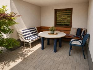 a patio with a table and chairs and a window at Apartament4you - Szczycionek in Korpele