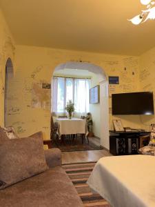 a living room with a table and a tv at Aregak B&B and Tours in Goris