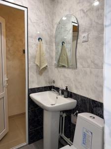 a bathroom with a sink and a toilet and a mirror at Aregak B&B and Tours in Goris +41 photos