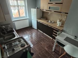 a small kitchen with a stove and a sink at Ewula in Giżycko