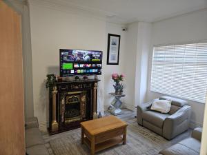 a living room with a couch and a fire place at New Horizon Lodge in Leigh +30 photos