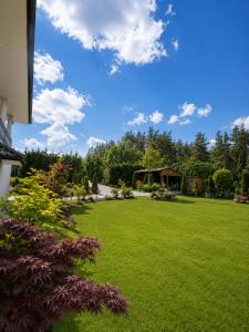 a lawn with a gazebo in a park at Apartament4you - Szczycionek in Korpele