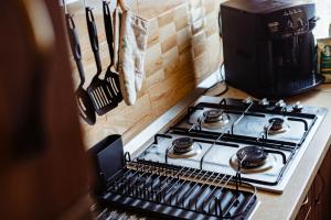 a stove top oven in a kitchen next to a counter at Casa de oaspeți in Brad +14 photos