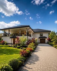 a house with a pathway leading to the front yard at Apartament4you - Szczycionek in Korpele