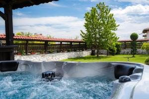 a hot tub in a backyard with water at Villa Ploski in Ploski