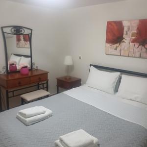 a bedroom with a bed with two towels on it at Guest House Mary in Porto Heli +73 photos