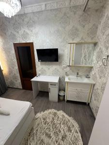 a bathroom with a sink and a mirror at LAYALI boutique TERRACE & Café in Bukhara +77 photos