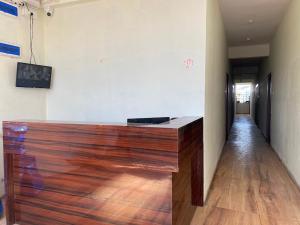 a wooden counter in a room with a hallway at Rajyog Resort in Dhule