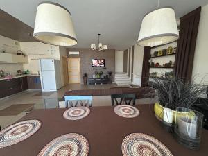 a kitchen and a living room with a dining table at Villa Life Family Sea House in Zatoka +9 photos