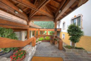 a large building with a wooden ceiling and a walkway at Hotel Panoramic in Auronzo di Cadore
