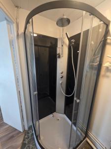 a shower with a glass enclosure in a bathroom at Côté Jardin in Bolbec +4 photos