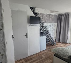 a room with a white closet and a staircase at Côté Jardin in Bolbec