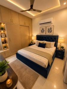 a bedroom with a large bed and a couch at Amantra in Sohāna