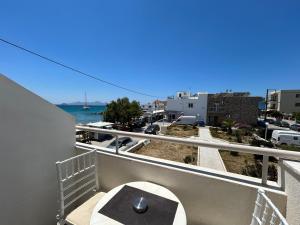 a balcony with a table and a view of the ocean at Annoula Studios and Apartments in Kardamaina