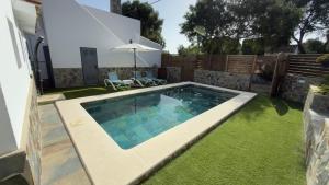 a swimming pool in the backyard of a house at Casa La Herradura 1 in Vejer de la Frontera
