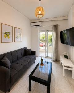 a living room with a couch and a table at Linda's Apartment in Ialysos +8 photos