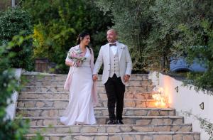 a bride and groom walking down a stone steps with a fire at Agriturismo La Terrazza su Farfa in Castelnuovo di Farfa