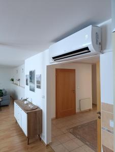 a living room with a room with a ceiling fan at Apartmány Frýda in Luhačovice
