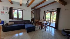 a living room with a couch and a table at Dom u Julii Bieszczady in Ustrzyki Dolne