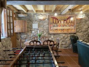 a stone room with a table and a foos ball at Casa das Marias by Gerês Casas in Geres