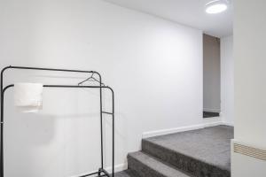 a staircase in a house with white walls and a stair case at Studio Apartment Fully Equipeed with WiFi and Netflix in Ilkeston