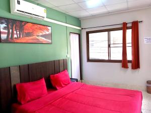 a bedroom with a bed with red sheets and a window at U&D guest house in Bangkok +13 photos