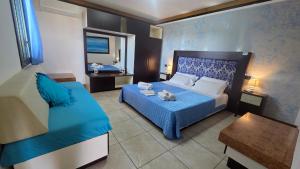 a hotel room with a bed and a mirror at Hotel Alba Chiara Sant'Andrea Salento in SantʼAndrea
